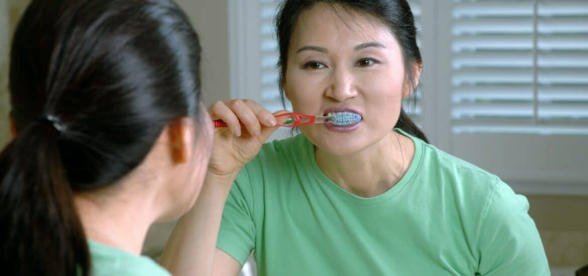 woman brushing teeth